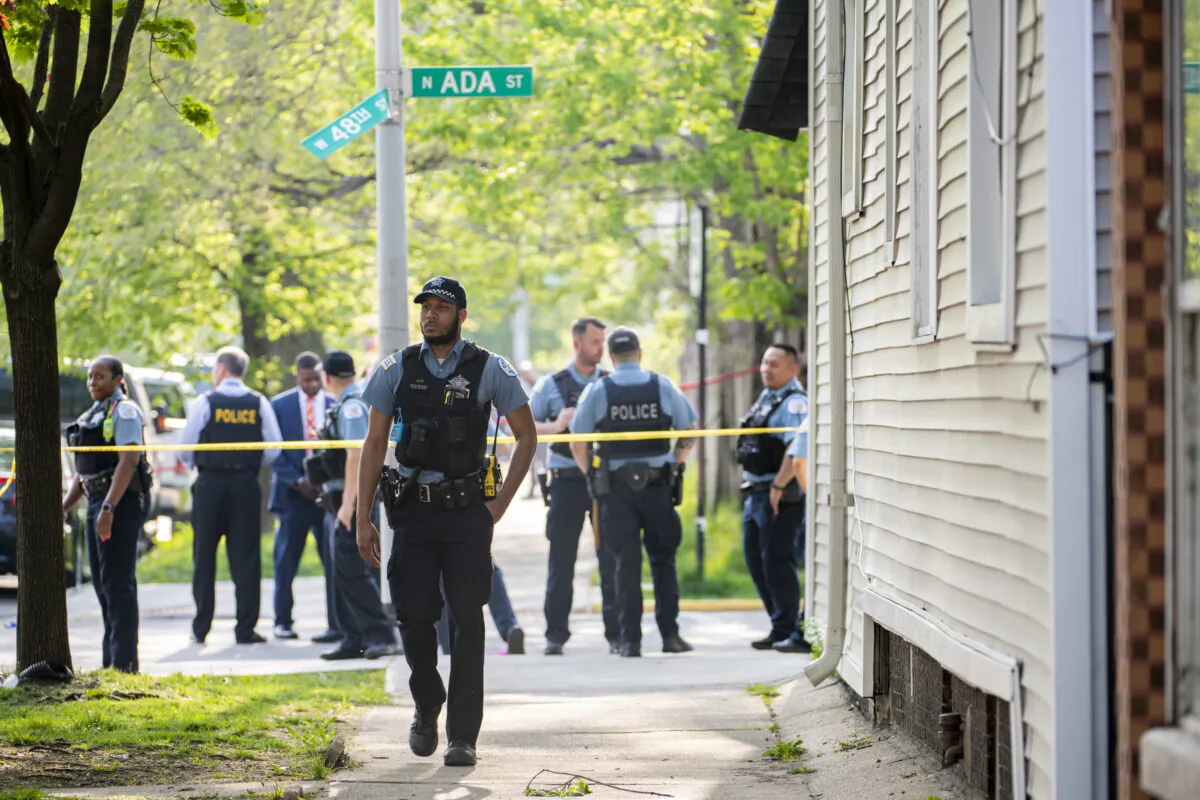 Chicago police work the scene of a fatal drive-by shooting in the 4800 block of South Ada Street, in the Back of the Yards neighborhood in Chicago, on May 10, 2022. (Tyler Pasciak LaRiviere/Chicago Sun-Times via AP)