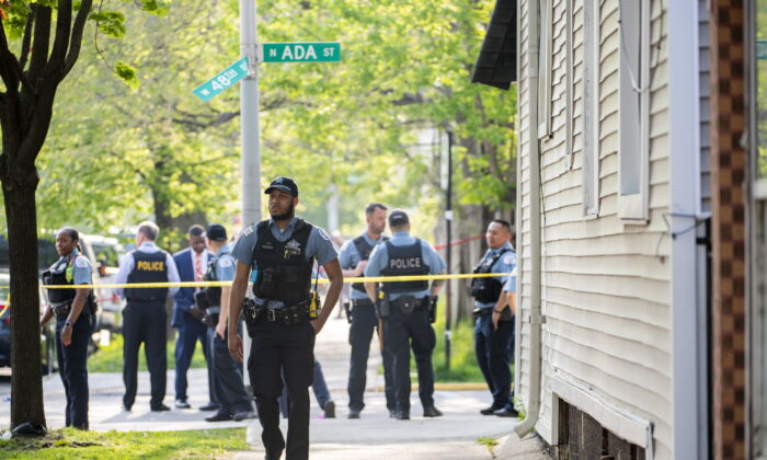 Chicago police work the scene of a fatal drive-by shooting in the 4800 block of South Ada Street, in the Back of the Yards neighborhood in Chicago, on May 10, 2022. (Tyler Pasciak LaRiviere/Chicago Sun-Times via AP)