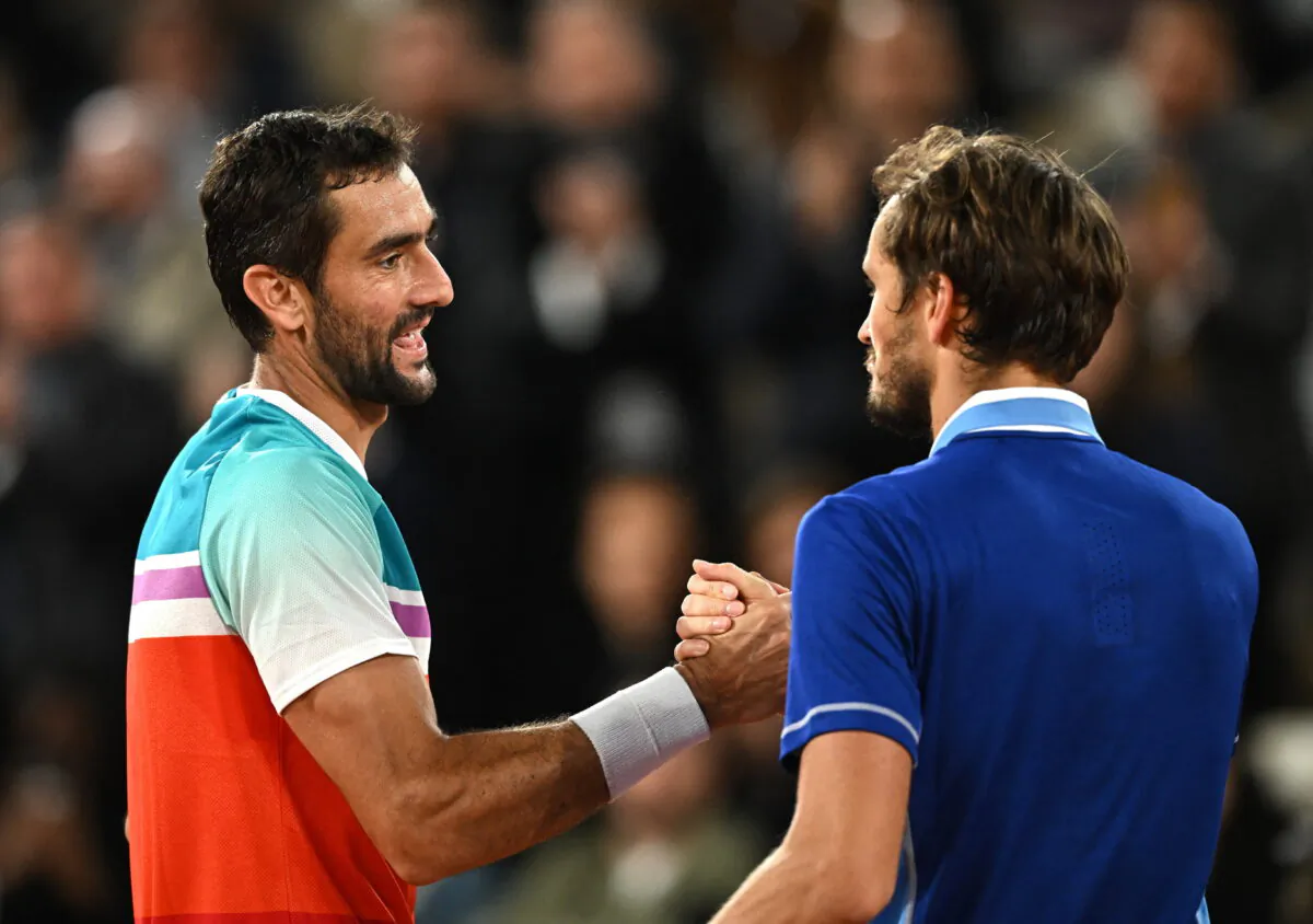 Croatia's Marin Cilic (L) shakes hands with Russia's Daniil Medvedev after winning his fourth round match at the French Open in Paris in on May 30, 2022. (Dylan Martinez/Reuters)