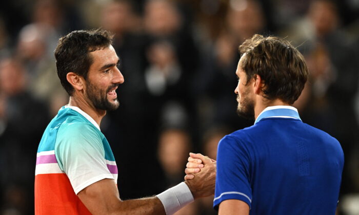 Croatia's Marin Cilic (L) shakes hands with Russia's Daniil Medvedev after winning his fourth round match at the French Open in Paris in on May 30, 2022. (Dylan Martinez/Reuters)