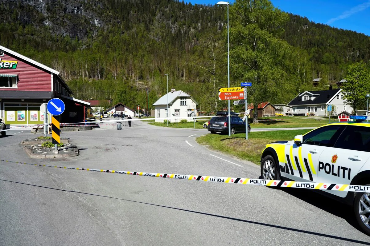 A police vehicle is parked behind a barrier tape on the side of the road, following attacks, in Nore, Numedal region, Norway, on May 20, 2022. (Lise Aserud/NTB/via Reuters)