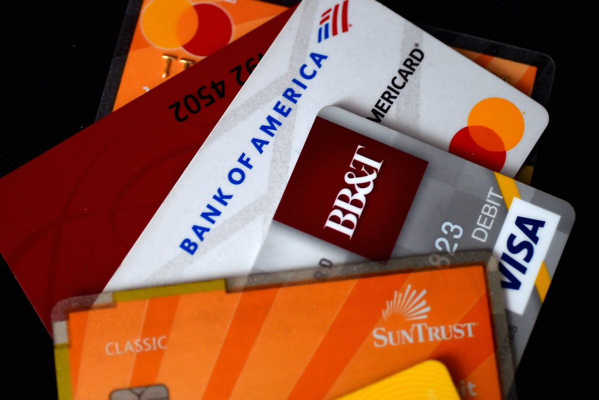 This illustration picture shows debit and credit cards arranged on a desk in Arlington, Virginia on April 6, 2020. (OLIVIER DOULIERY/AFP via Getty Images)