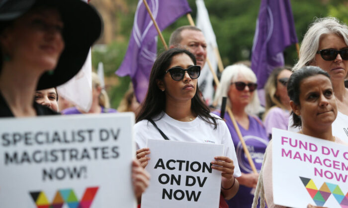 Women hold signs referencing action against domestic violence during the Sydney International Women's Day march in Sydney, Australia, on March 7, 2020. (Lisa Maree Williams/Getty Images)