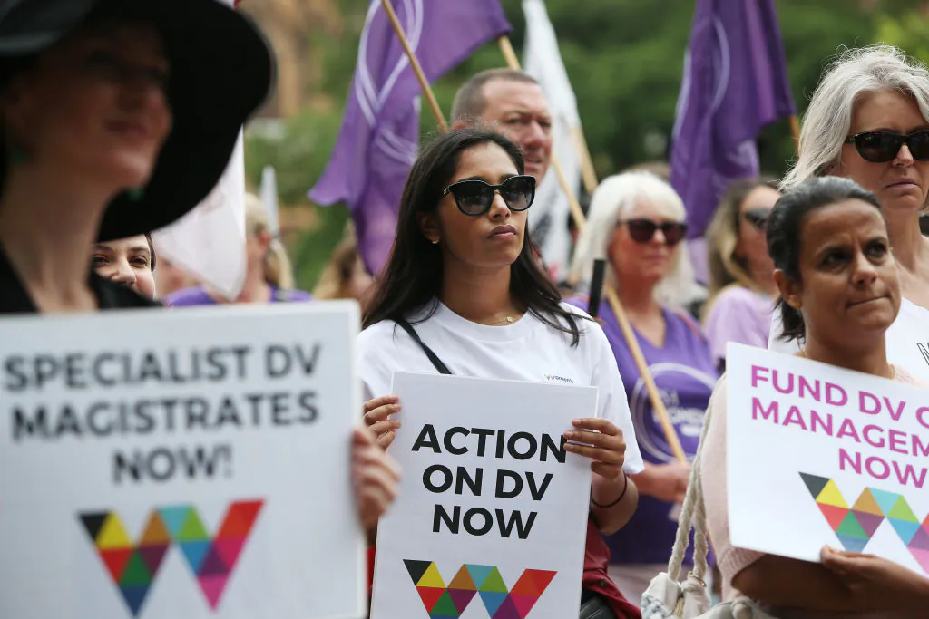 Women hold signs referencing action against domestic violence during the Sydney International Women's Day march in Sydney, Australia, on March 7, 2020. (Lisa Maree Williams/Getty Images)
