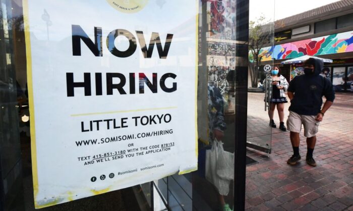 A "now hiring" sign is posted in the window of an ice cream shop in Los Angeles, Calif., on Jan. 28, 2022. (Frederic J. Brown/AFP via Getty Images)