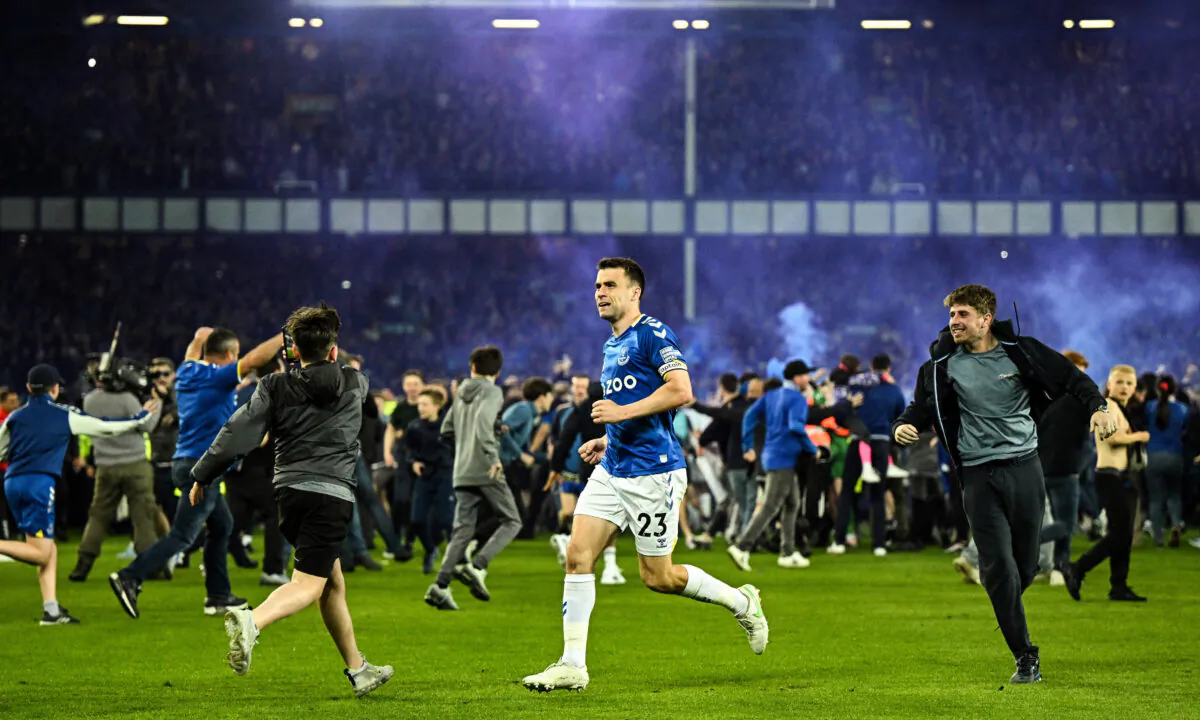Everton's Irish defender Seamus Coleman celebrates with Everton's fans invading the football pitch to celebrate at the end of the English Premier League football match between Everton and Crystal Palace at Goodison Park in Liverpool, northwest England, on May 19, 2022. (Oli Scarff/AFP via Getty Images)