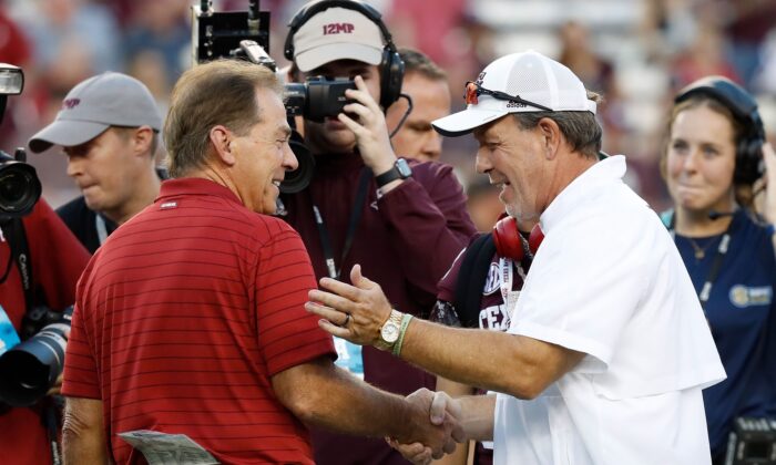 Head coach Nick Saban of the Alabama Crimson Tide  and head coach Jimbo Fisher of the Texas A&M Aggies  meet before the game at Kyle Field,in College Station, Texas, on October 9, 2021 . (Bob Levey/Getty Images)