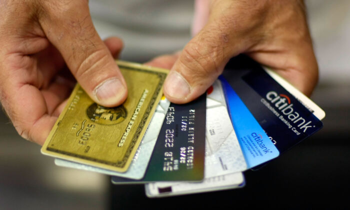 A man holds several credit cards in a 2009 file photo. (Joe Raedle/Getty Images)