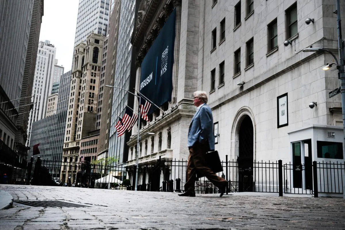 People walk by the New York Stock Exchange (NYSE) in New York on May 12, 2022. (Spencer Platt/Getty Images)
