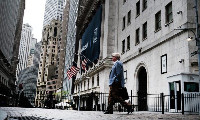 People walk by the New York Stock Exchange (NYSE) in New York on May 12, 2022. (Spencer Platt/Getty Images)