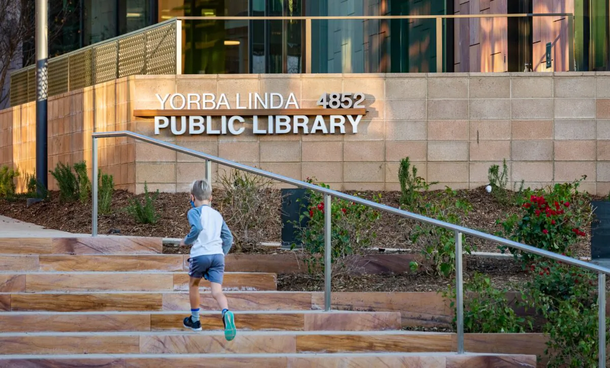 A child runs up the steps of the Yorba Linda Library and Cultural Arts Center in Yorba Linda, Calif., on Nov. 30, 2020. (John Fredricks/The Epoch Times)