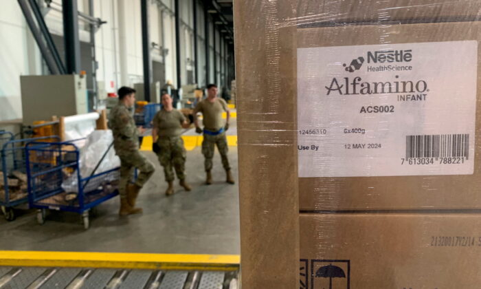 Soldiers load up boxes of baby formula ready for first shipments to US from Europe at Ramstein US army base in Germany, on May 21, 2022. (Erol Dogrudogan/Reuters)