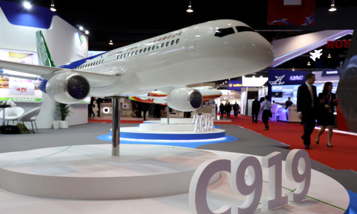 A model of the Commercial Aircraft Corp. of China Ltd. (Comac) C919 aircraft sits on display at the Singapore Airshow held at the Changi Exhibition Center in Singapore, on Feb. 6, 2018. The state-owned Chinese company seeks to chase markets in Asia and Africa. (Seong Joon Cho/Bloomberg via Getty Images)