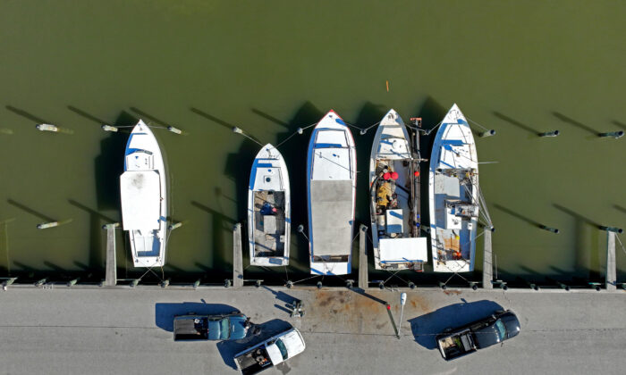 Boats sit docked at the Watermens Boat Basin in Chester, Md., on March 14, 2022. (Jim Watson/AFP)