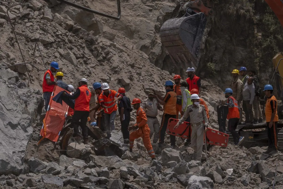 Rescue workers prepare to retrieve the body of a victim at the site of a collapsed tunnel in Ramban district, south of Srinagar, Indian controlled Kashmir, on May 20, 2022. (Dar Yasin/AP Photo)