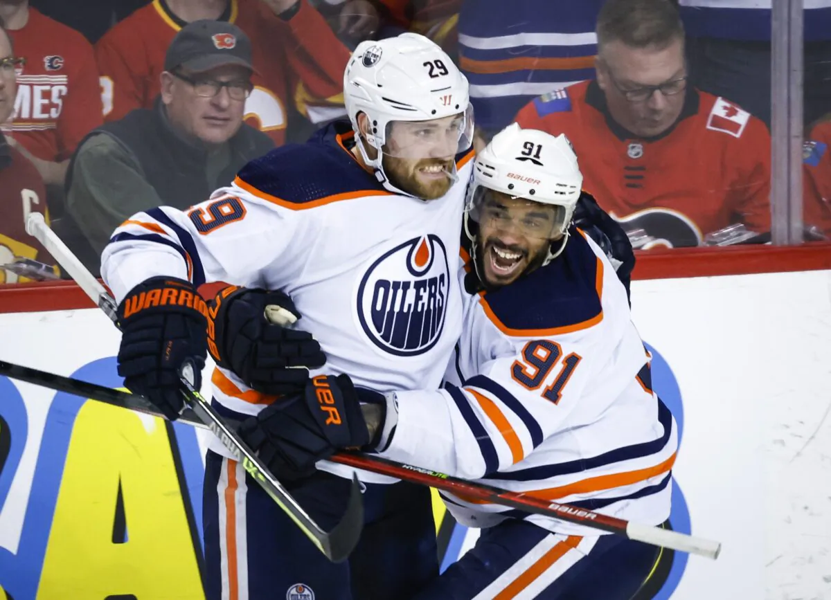 Edmonton Oilers center Leon Draisaitl (L) celebrates his goal against the Calgary Flames with Evander Kane, in Calgary, Alberta, Canada, on May 20, 2022. (Jeff McIntosh/The Canadian Press via AP)