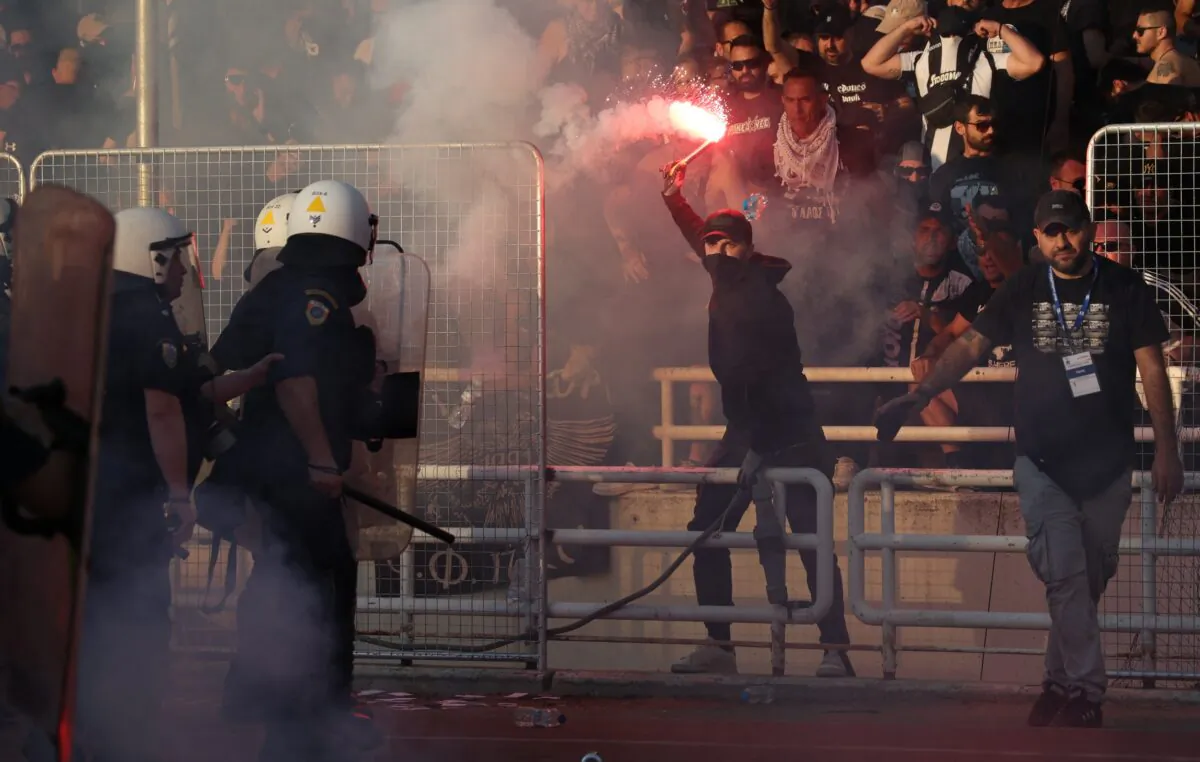 Police and fans clash inside the stadium before the match as match is delayed, in Athens, Greece, on May 21, 2022. (Alkis Konstantinidis/Reuters)