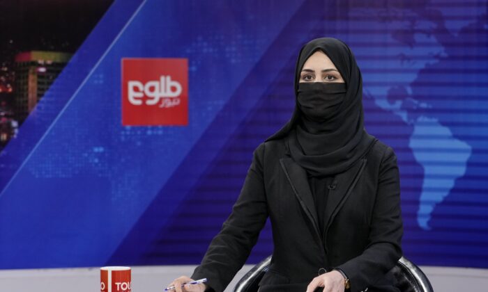 TV anchor Khatereh Ahmadi wears a face covering as she reads the news on TOLO NEWS, in Kabul, Afghanistan, on May 22, 2022. (Ebrahim Noroozi/AP Photo)