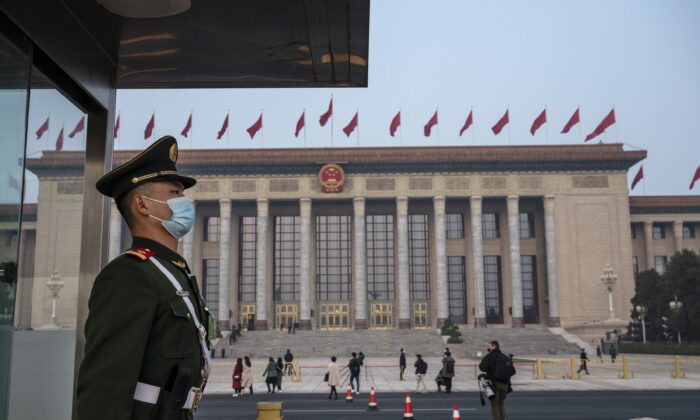 A police officer stands guard before the closing session of the Chinese People's Political Consultative Conference at the Great Hall of the People in Beijing, China, on March 10, 2022. (Kevin Frayer/Getty Images)