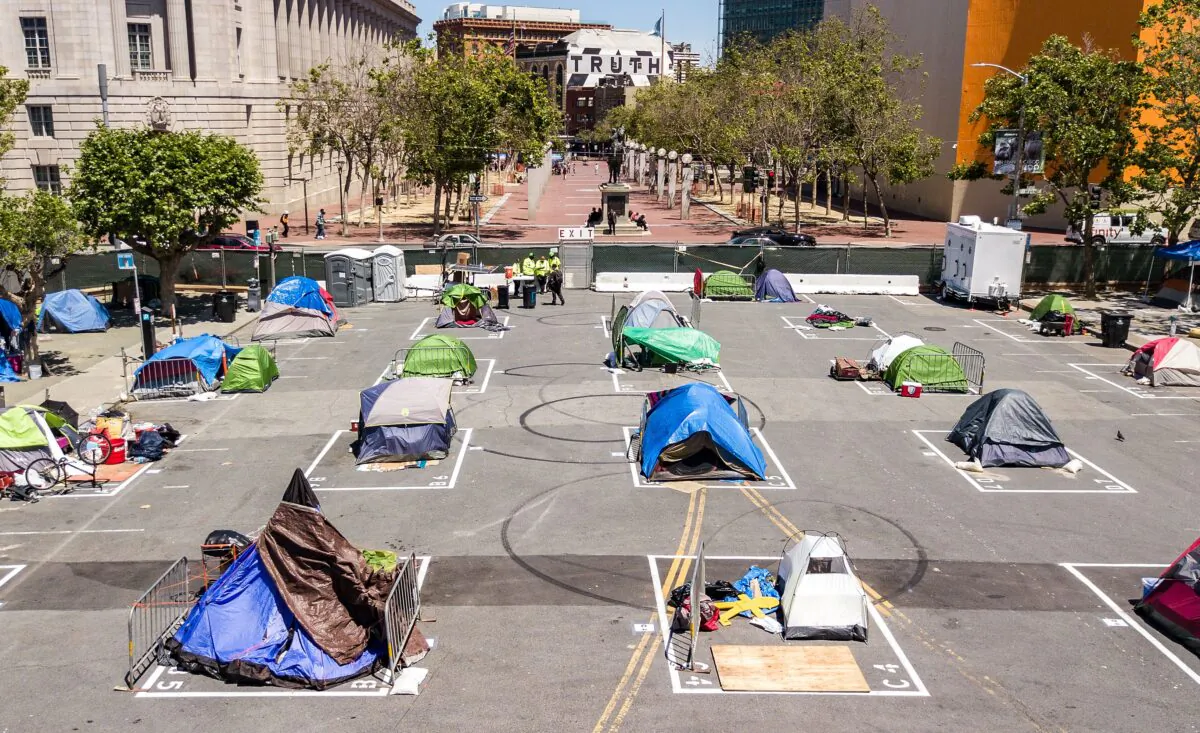 File photo: Rectangles are painted on the ground to encourage homeless people to keep social distancing at a city-sanctioned homeless encampment across from City Hall in San Francisco on May 22, 2020, amid the pandemic. (Josh Edelson/AFP via Getty Images)