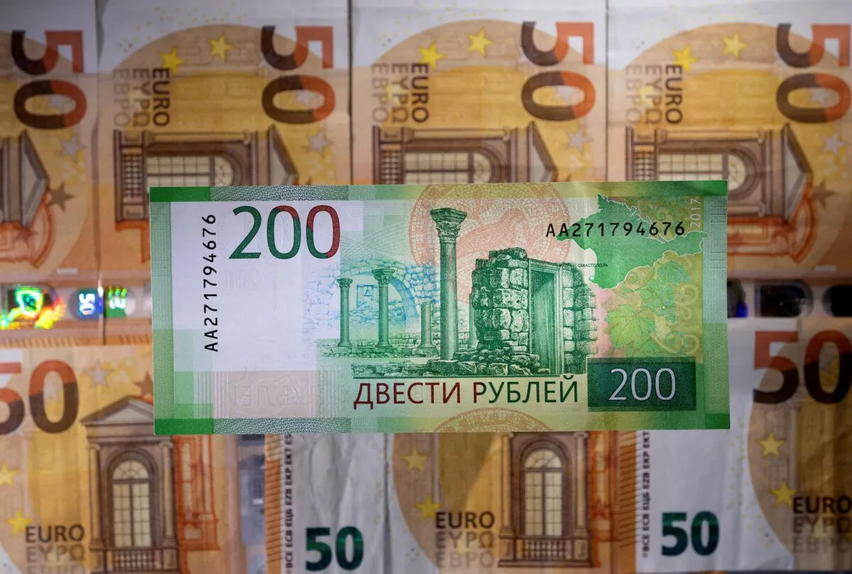 A Russian ruble banknote is placed on euro banknotes in an illustration taken on March 1, 2022. (Dado Ruvic/Illustration/Reuters)