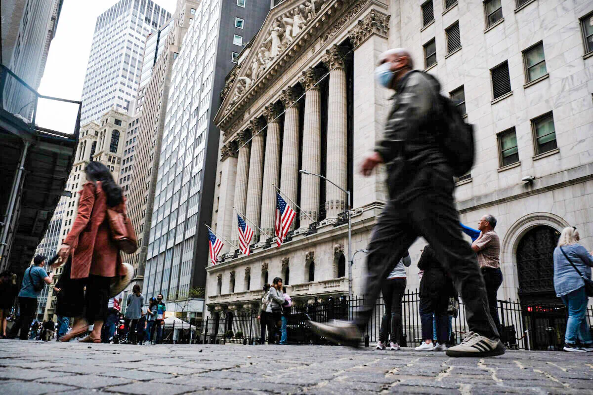 People walk by the New York Stock Exchange on May 5, 2022. (Spencer Platt/Getty Images)