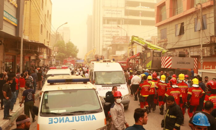 Iran's first responders and civilians will meet in Abadan, Iran, on May 23, 2022, where a 10-story building collapsed.  (WANA via Reuters (West Asia News Agency))