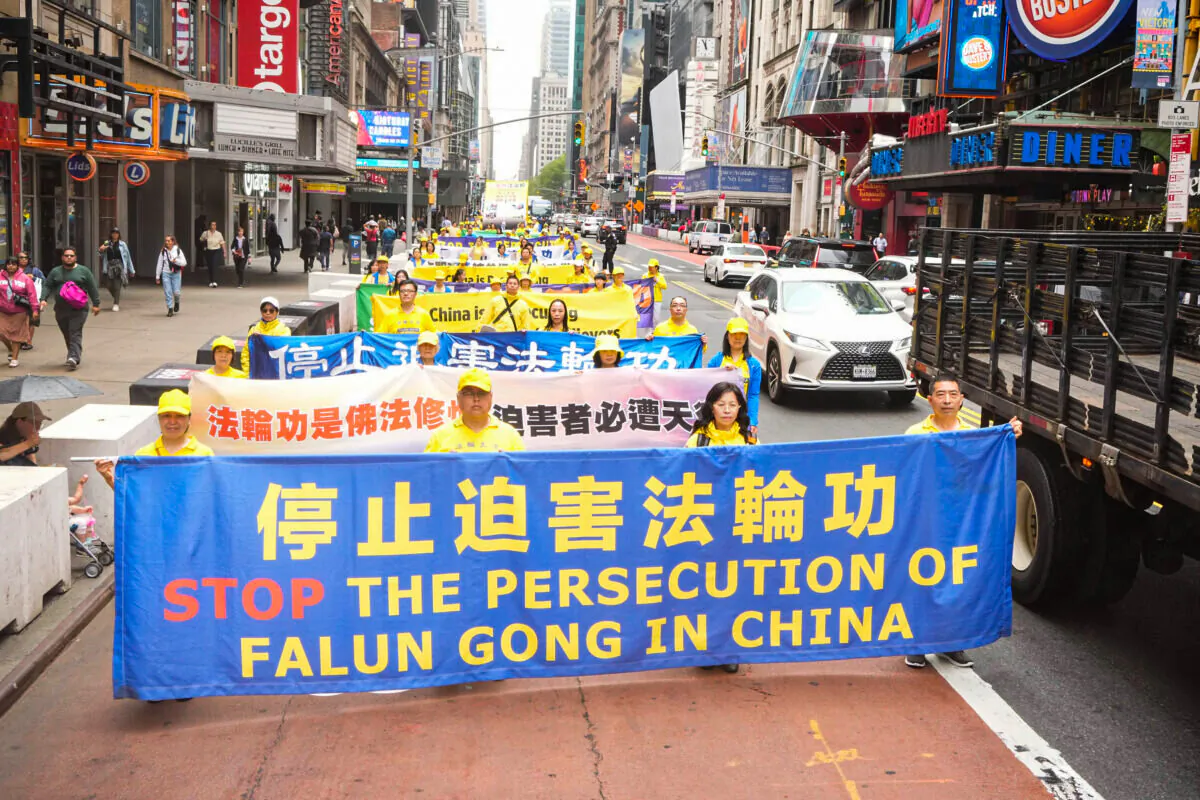 Falun Gong practitioners take part in a parade marking the 30th anniversary of the spiritual discipline's introduction to the public, in New York on May 13, 2022. (Larry Dye/The Epoch Times)