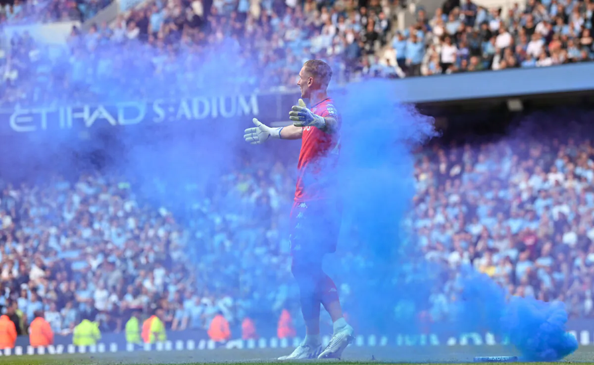 Aston Villa goalkeeper Robin Olsen reacts after a blue flare is thrown onto the pitch during the Premier League match between Manchester City and Aston Villa at Etihad Stadium in Manchester, England, on May 22, 2022. (Stu Forster/Getty Images)