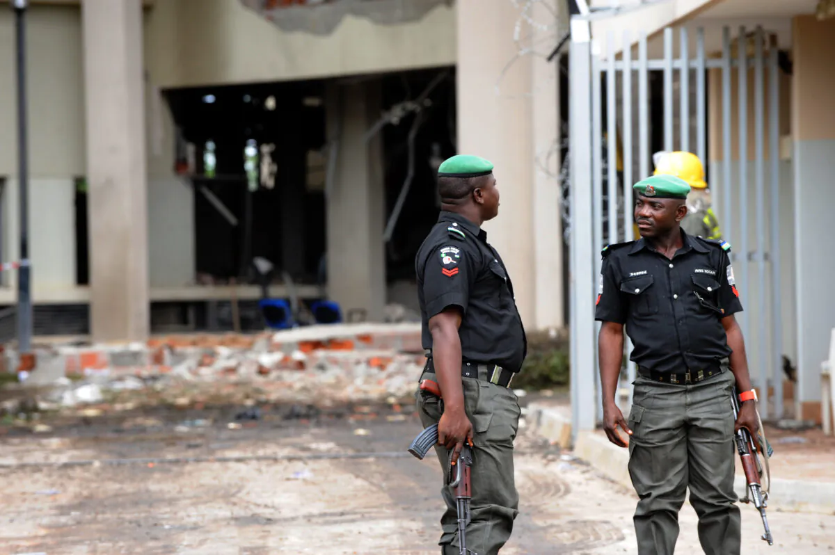 Policemen keep watch at the scene at the United Nations building in Nigeria on Aug. 27, 2011. (Pius Utomi Ekpei/AFP via Getty Images)