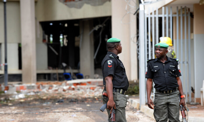 Policemen keep watch at the scene at the United Nations building in Nigeria on Aug. 27, 2011. (Pius Utomi Ekpei/AFP via Getty Images)