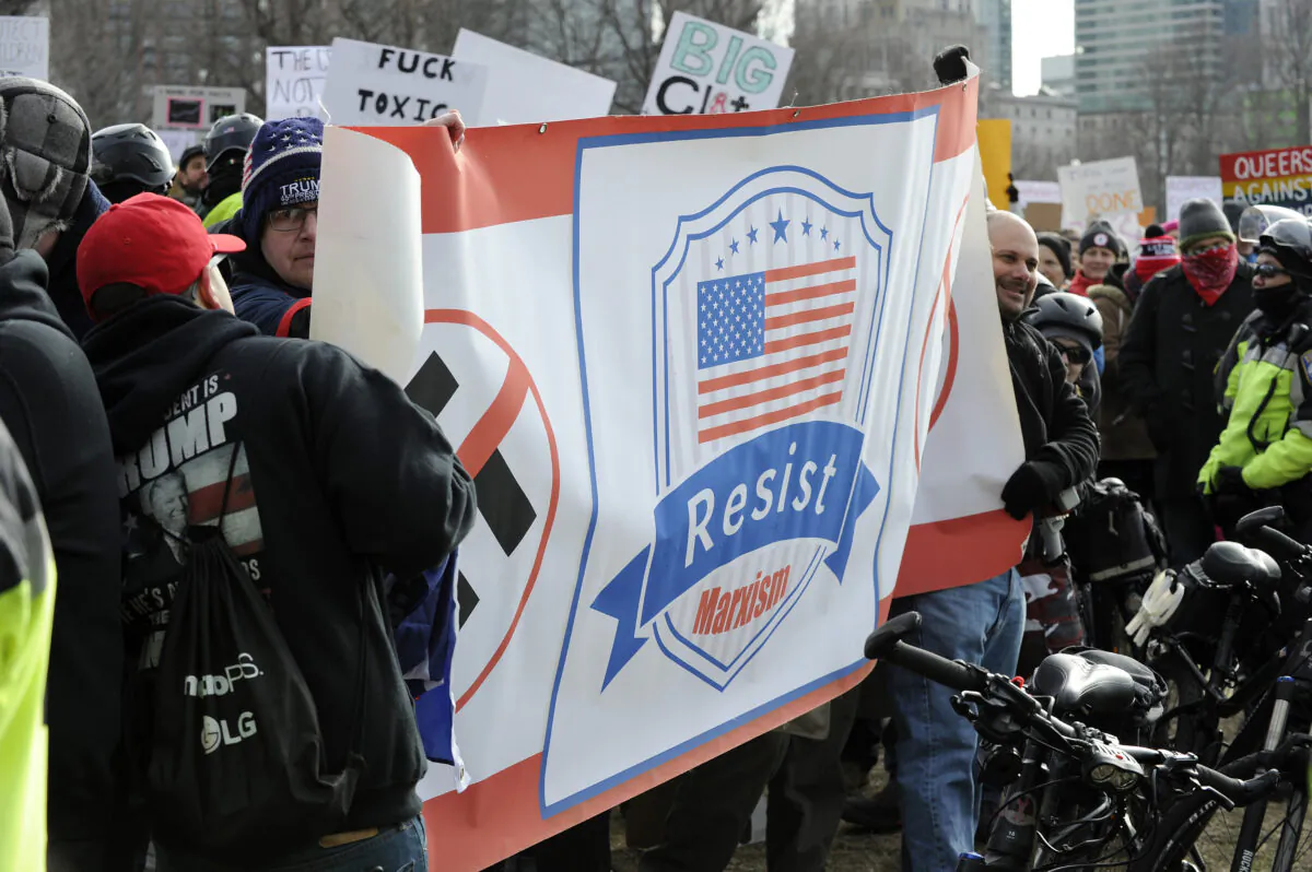 People unveil a banner calling for resisting Marxism at Boston Common in Boston, Mass., on Jan. 19, 2019. (Joseph Prezioso/AFP via Getty Images)