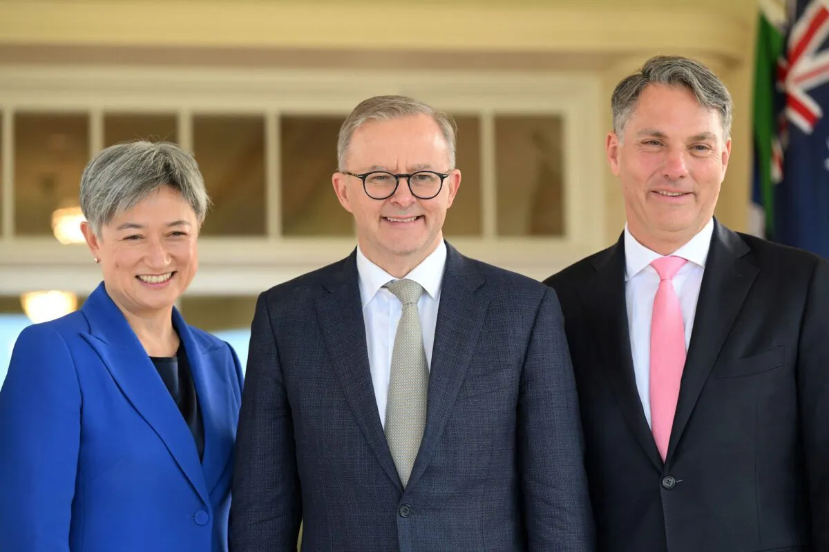 Australia's new Prime Minister Anthony Albanese (C) poses with his new cabinet ministers, Penny Wong (L) and Richard Marles, after the oath-taking ceremony at Government House in Canberra on May 23, 2022. (Saeed Khan/AFP via Getty Images)