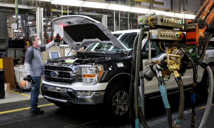 An assembly worker of Ford Motor works on an F-series pickup truck at the Dearborn Truck Plant in Dearborn, Mich., on Jan. 26, 2022. (Rebecca Cook/Reuters)