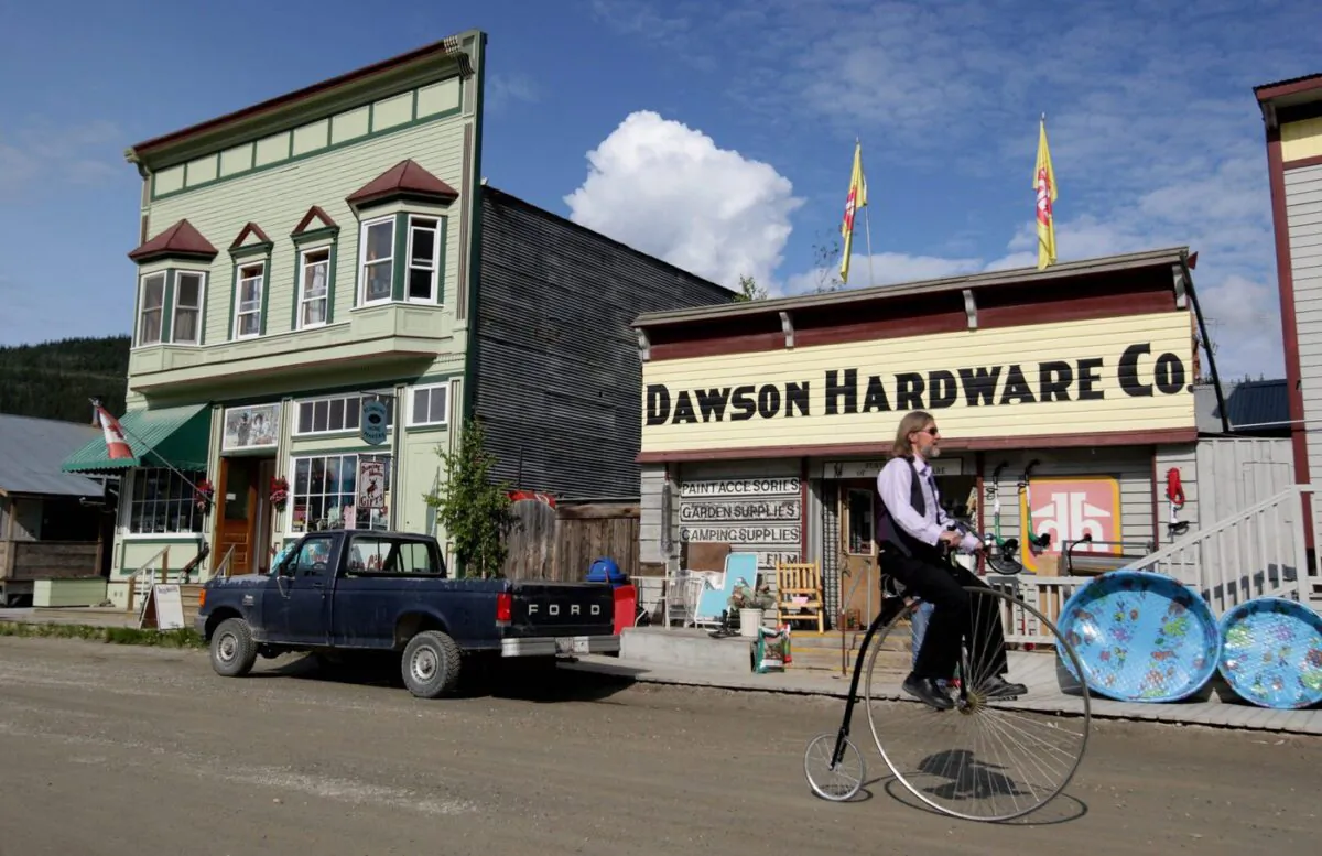 Eldo Enns rides his penny farthing bicycle in Dawson City, Yukon, on June 19, 2009. (The Canadian Press/Darryl Dyck)