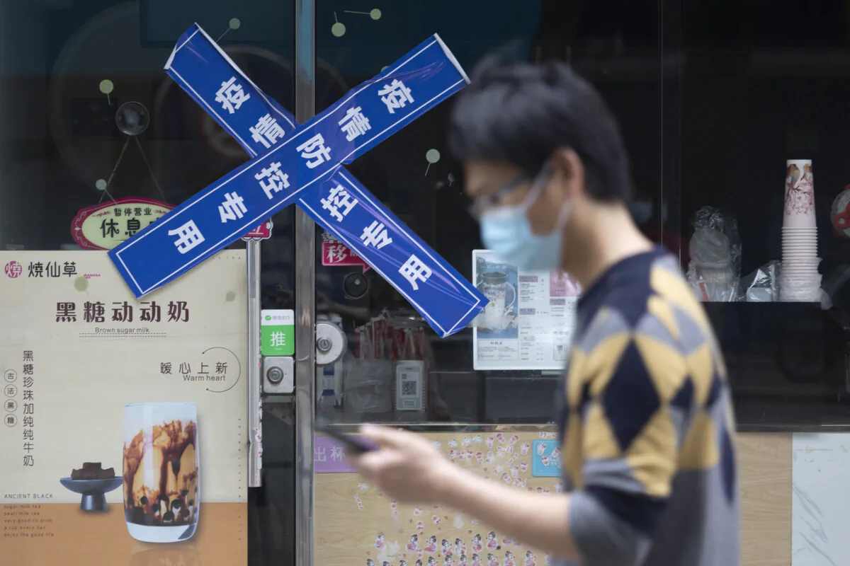 A man walks on the street during a scheduled lockdown break in Shanghai, on May 23, 2022. (Hu Chengwei/Getty Images)