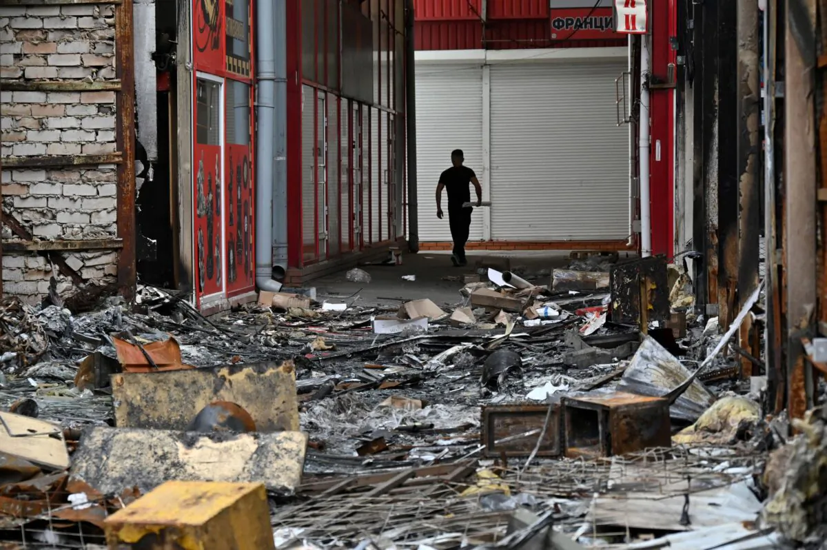 A man walks at one of Europe's largest clothing market "Barabashovo", destroyed by shelling in Kharkiv, on May 21, 2022. (Sergey Bobok/AFP via Getty Images)