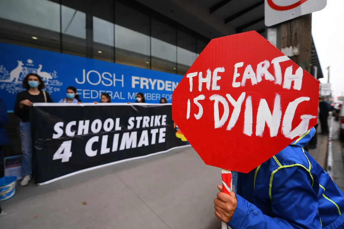 Protesters gather during a School Strike 4 Climate protest outside Australian Treasurer Josh Frydenberg's office in Melbourne, Australia, on May 13, 2022. (AAP Image/James Ross)