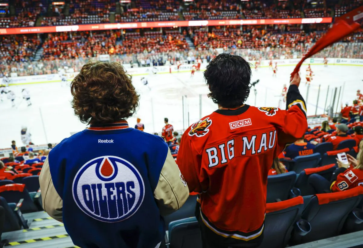 Edmonton Oilers and Calgary Flames fans watch the warm-up prior to NHL second-round playoff hockey action in Calgary on May 20, 2022. (The Canadian Press/Jeff McIntosh)