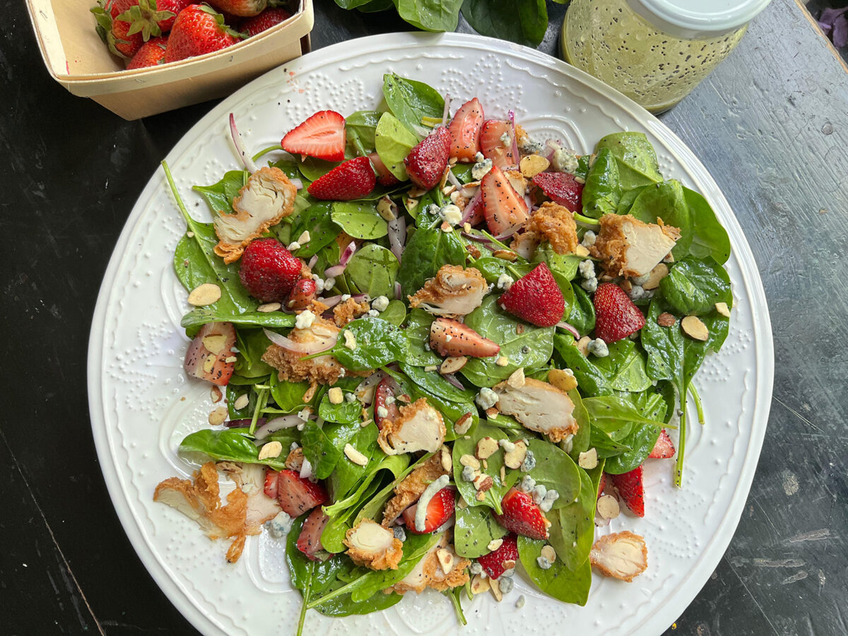 Fresh, local strawberries add a sweet touch to this easy spring salad with fried chicken. (Gretchen McKay/Pittsburgh Post-Gazette/TNS)