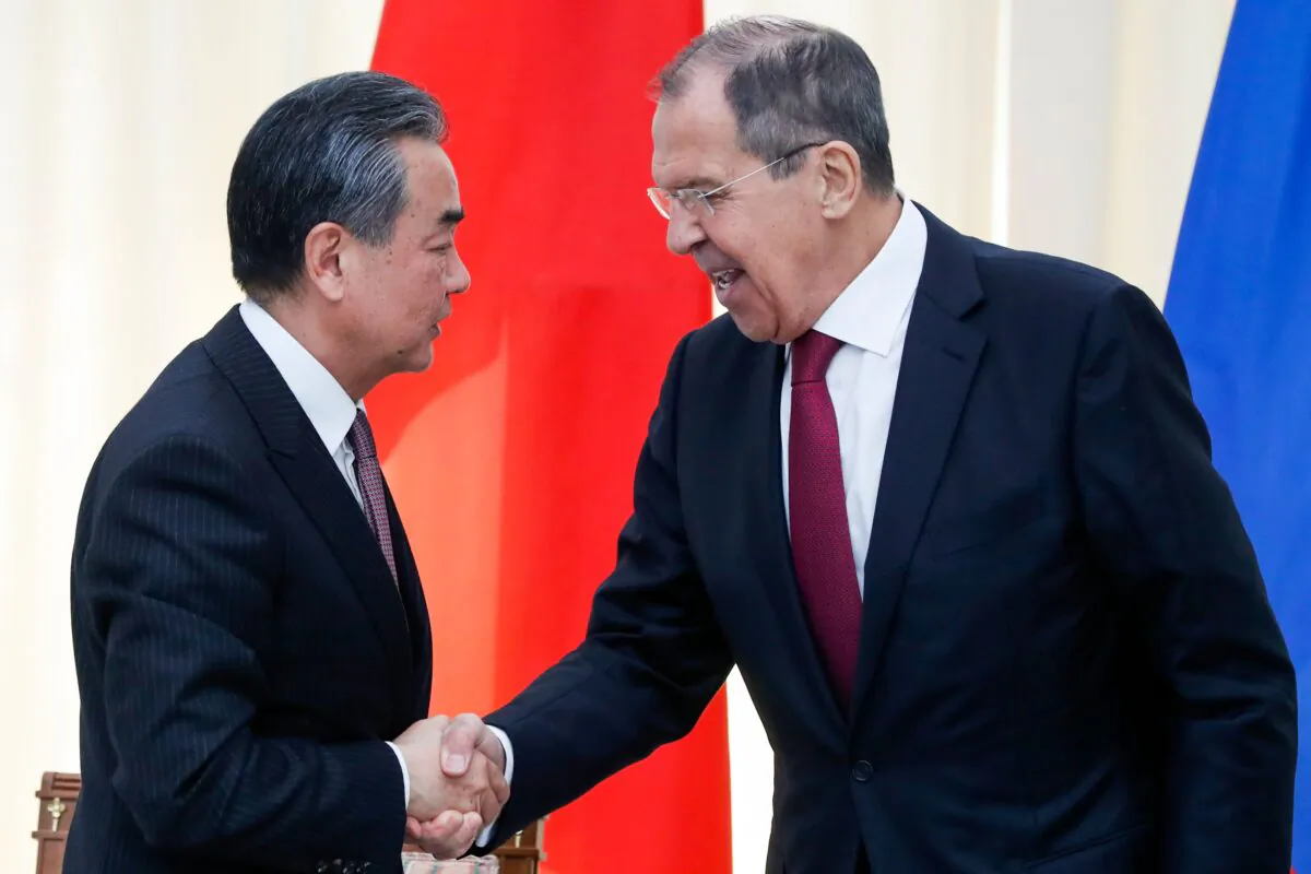 Russian Foreign Minister Sergei Lavrov (R) shakes hands with his Chinese counterpart Wang Yi at the end of a joint press conference following their meeting in Sochi, Russia, on May 13, 2019. (Pavel Golovkin/AFP via Getty Images)