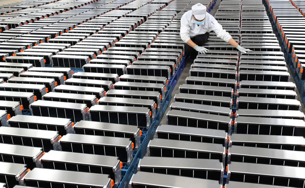 A worker is pictured with car batteries at a factory that makes lithium batteries for electric cars and other uses, in Nanjing in China's eastern Jiangsu Province, on March 12, 2021. (STR/AFP via Getty Images)