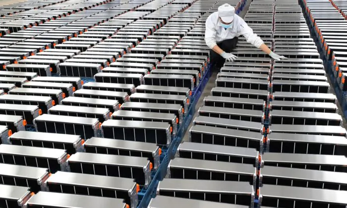 A worker with car batteries at a factory for Xinwangda Electric Vehicle Battery Co. Ltd, which makes lithium batteries for electric cars and other uses, in Nanjing in China's eastern Jiangsu Province, on March 12, 2021. - China OUT (Photo by STR / AFP) / China OUT (Photo by STR/AFP via Getty Images)