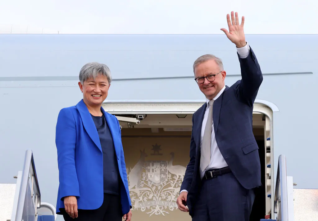 Prime Minister Anthony Albanese stands with Foreign Minister Penny Wong, at the door of their plane in Canberra, Australia, on May 23, 2022. (David Gray/Getty Images)