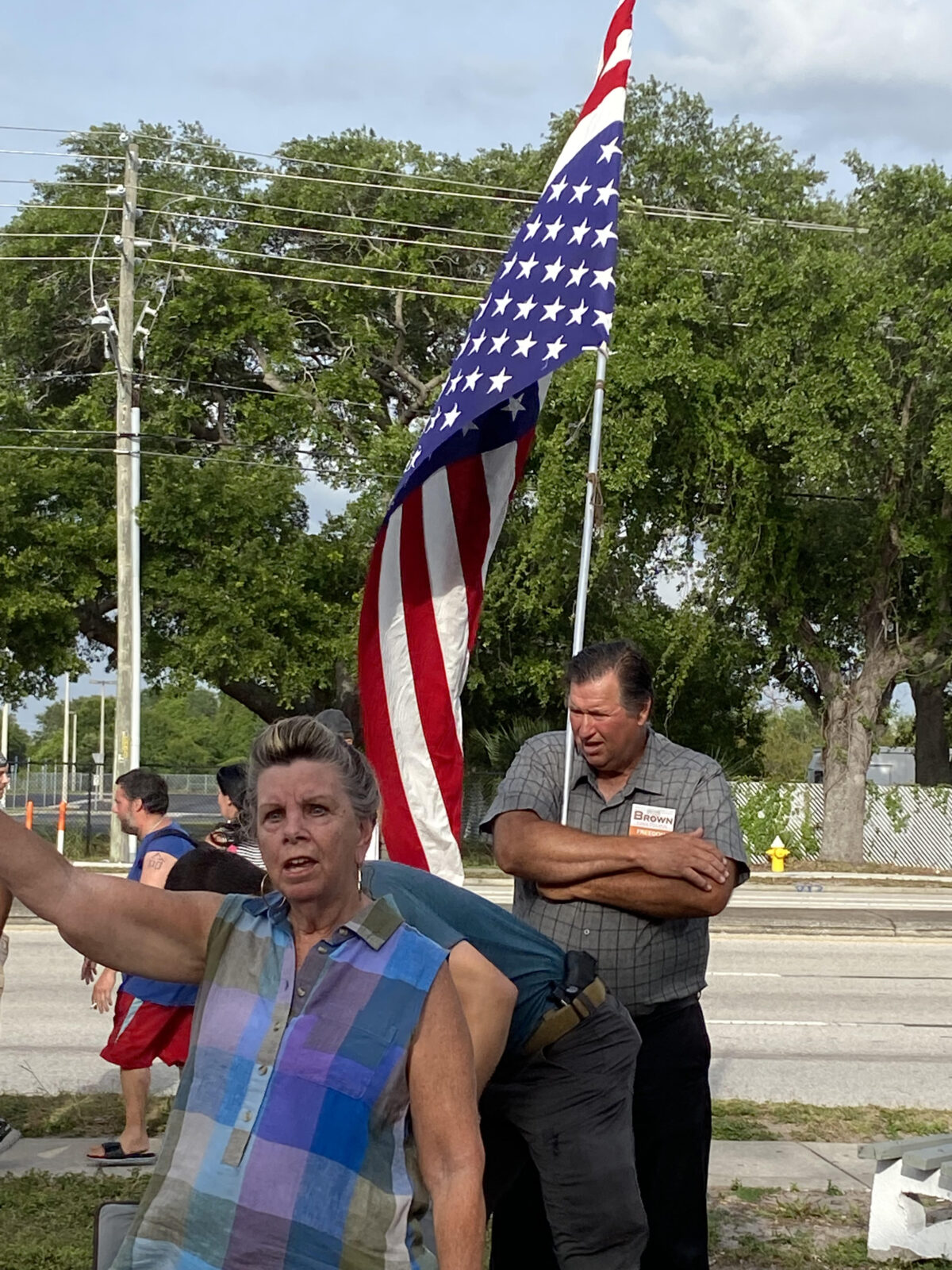 An attendee holds an American flag in the upside down position at the May 22, 2022 prayer vigil and rally in support of Jeremy Brown, January 6 prisoner and candidate for Florida House of Representatives, District 62. According to United States Flag Code, flying the American flag upside down is "a signal of dire distress in instances of extreme danger to life or property."