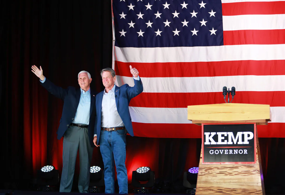 Georgia Gov. Brian Kemp (R) stands with former U.S. vice president Mike Pence at a campaign event at the Cobb County International Airport in Kennesaw, Ga., on May 23, 2022. (Joe Raedle/Getty Images)