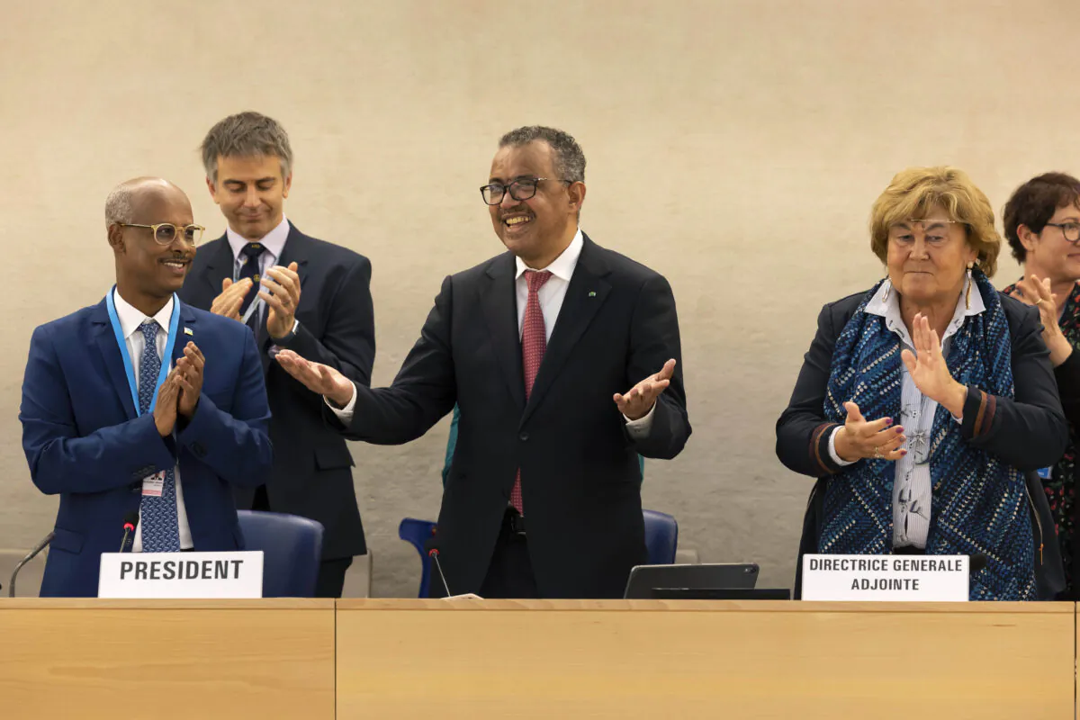 Tedros Adhanom Ghebreyesus, Director General of the World Health Organization (WHO) (C), celebrates his reelection, during the 75th World Health Assembly at the European headquarters of the United Nations in Geneva, on May 24, 2022. (Salvatore Di Nolfi/Keystone via AP)