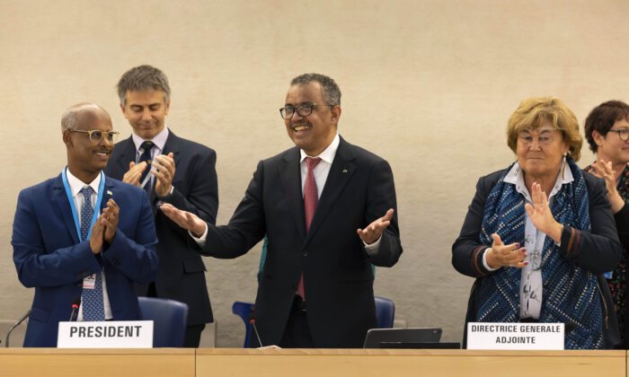 Tedros Adhanom Ghebreyesus, Director General of the World Health Organization (WHO) (C), celebrates his reelection, during the 75th World Health Assembly at the European headquarters of the United Nations in Geneva, on May 24, 2022. (Salvatore Di Nolfi/Keystone via AP)