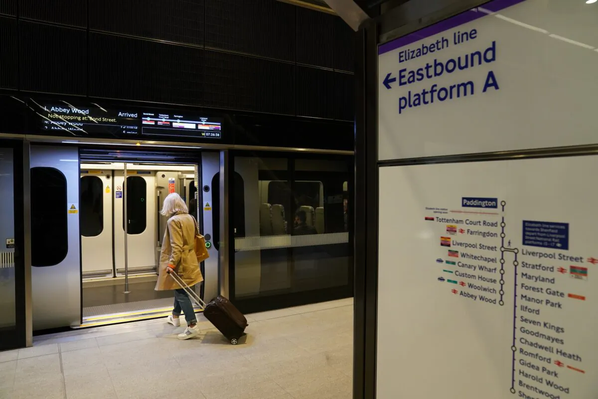 A passenger boards an Elizabeth Line train at Paddington station in London on May 24, 2022. (PA Media)