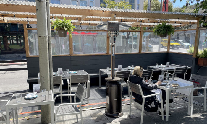 A lone customer sits in outdoor seating a restaurant in San Francisco, Calif., on May 11, 2022. (Justin Sullivan/Getty Images)